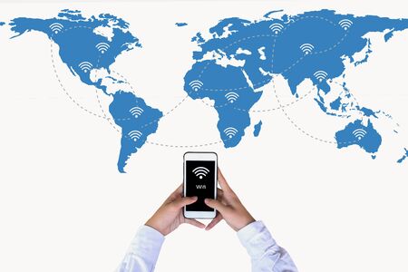 Hand holding smart phone on world map network and wireless communication network, abstract image visualの写真素材