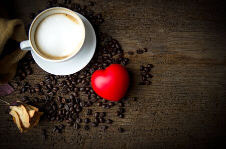 Cup coffee and heart on the old woodenの写真素材