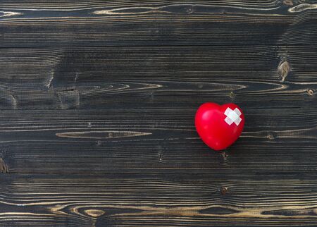 One single alone red heart love shape hand exercise ball on the old woodenの写真素材