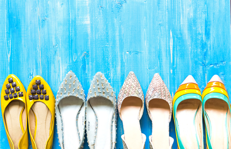 Collection of women's shoes on blue backgroundの写真素材