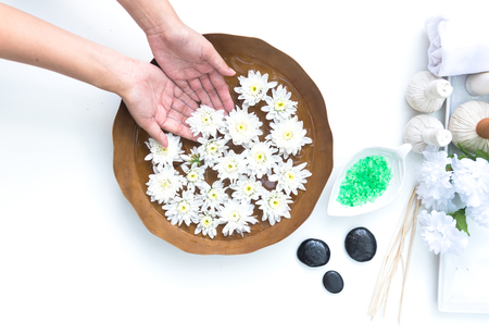 Spa treatment and product for hand and foot spa with flowers and water, wooden background;の写真素材