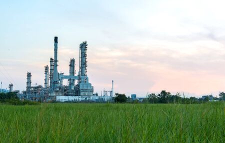 Oil refinery plant at sunrise with sky backgroundの写真素材