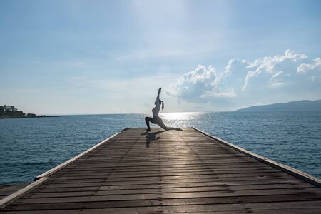 Caucasian woman practicing yoga at seashoreの写真素材