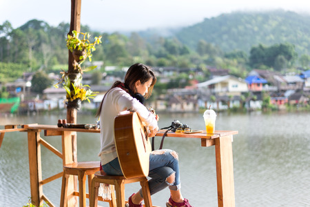 Young women playing acoustic guitarの写真素材
