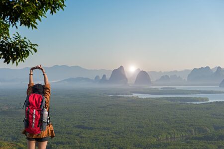 Hiker woman feeling victorious facing on the mountain, Thailandの写真素材