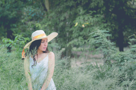 Portrait of happy and enjoying young woman on a meadow on a sunny summer day, vintage toneの写真素材