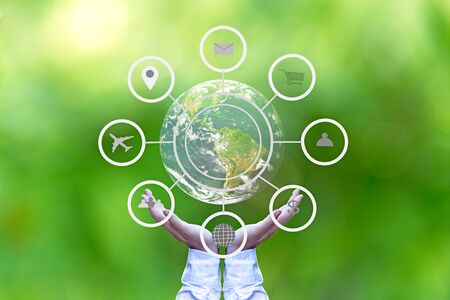 Hand holding globe with abstract global business cycle sketch on green background. Elements of this image furnished by NASAの写真素材