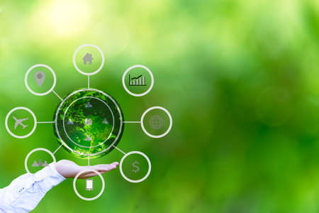 Hand holding globe with abstract global business cycle sketch on green background. Elements of this...