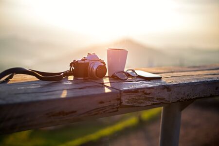 Cup with tea on table over mountains landscape with sunlight vintage. Beauty nature backgroundの写真素材