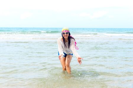 Fashion woman relax on the beach.  White sand, blue cloudy sky and crystal sea of tropical beach.の写真素材