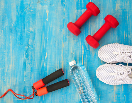 Fitness equipment and fresh water on the blue backgroundの写真素材