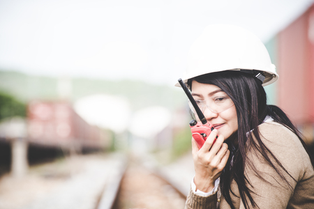 Engineer asia woman checking railways and call radio for civil and construction.  Engineer Concept.の写真素材