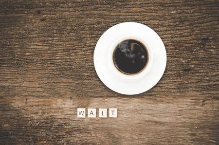 A cup of coffee with write waiting on white wooden table.  Lifestyle Conceptの写真素材
