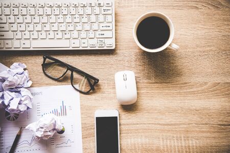 Business workplace with keyboard mouse and crumpled paper balls ,papers with graphs and diagrams .  Business Conceptの写真素材
