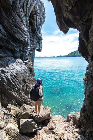 Travel people women tourist in a cave near the sea in Keo Sichang, Thailand. Travel Conceptの写真素材