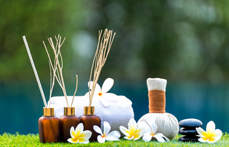 Spa treatment and product for hand and foot spa with flowers and water, soft focus; Spa herbal compressing ball , white frangipani flowers, Thailand. Greenery tone 2017の写真素材