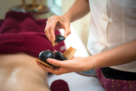 Treatment spa and massage people beauty for healthy lifestyle and relaxation.  Close up of salt and rock massage scrub.  Thai Spa.  Healthy Concept.の写真素材