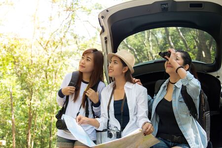 Group of beautiful young women walking in the forest, enjoying vacation, travel conceptの写真素材