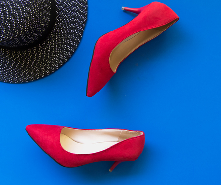 Fashion woman accessories set. Trendy fashion red shoes heels, stylish big hat. blue background.  Lifestyle Concept.の写真素材