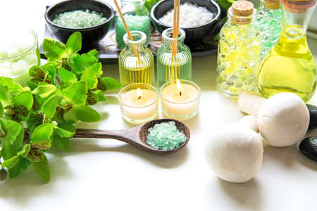 Thai Spa Treatments aroma therapy  salt and nature green sugar scrub and rock massage with green orchid flower on wooden white with candle. Thailand.  Healthy Concept. copy space,select and soft focusの写真素材