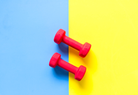 Fitness sports equipment top view, blue and yellow color background. Healthy Concept.の写真素材