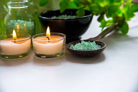 Thai Spa Treatments aroma therapy  salt and nature green sugar scrub and rock massage with green orchid flower on wooden white with candle. Thailand.  Healthy Concept. copy space,select and soft focusの写真素材