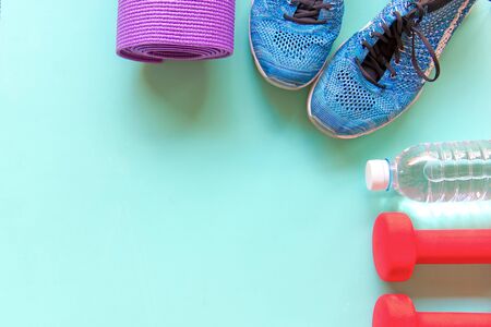 Healthy lifestyle for women diet with sport equipment, sneakers, and fresh bottle of water on wooden.  Healthy Concept.の写真素材