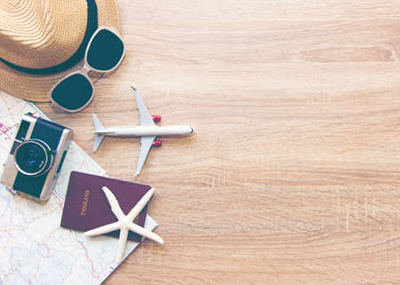 Tourist travel planning concept on map with passport, airplane, camera,hat and sunglasses.  Travel Conceptの写真素材