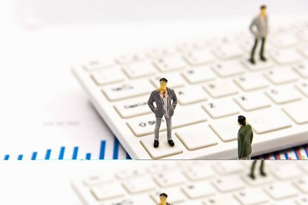 Miniature group businessman standing on the graph and thinking with project for presenting investment.  Investment and Business Concept.の写真素材
