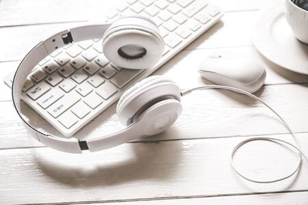 Headphones on the laptop with white cup coffee on wooden desk table . Music  and lifestyle concept. Top view with copy spaceの写真素材