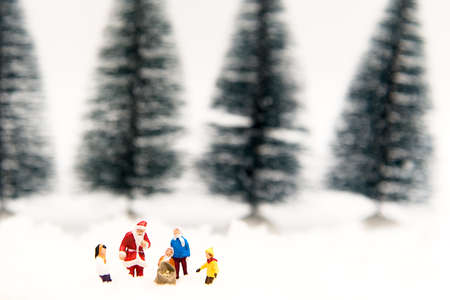 Miniature Santa Claus with Snow man make happy hour for children on Christmas day, Tree background.   Holiday Conceptの写真素材