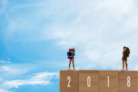 Miniature group traveler standing on wooden 2018 with  new year, blue sky background.  Holiday Conceptの写真素材