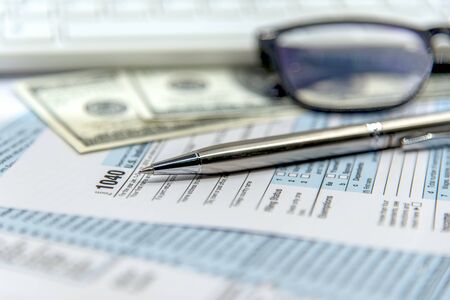 US tax form 1040 with pen and calculator. Tax form law document USA white mathematics.  Tax and business conceptの写真素材