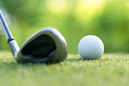 Golf club hitting golf ball along fairway towards green with copy space, green nature background.  Lifestyle Concept.  select focusの写真素材