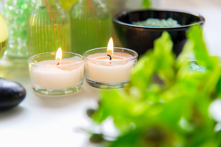 Thai Spa Treatments aroma therapy  salt and nature green sugar scrub and rock massage with green orchid flower on wooden white with candle. Thailand.  Healthy Concept. copy space,select and soft focusの写真素材