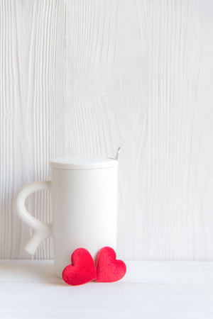 Valentine's Day with white cup coffee red heart on the cup, wood white background, copy space  Valentine Concept.の写真素材