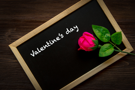 Pink Rose on the chalkboard for written Valentine Day.  Old wood background, copy space. Valentine Concept.の写真素材