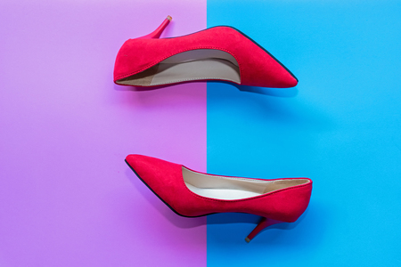 Fashion woman accessories set. Trendy red fashion shoes heels. Pink and blue pastel color background. Fashion and Lifestyle Concept.の写真素材