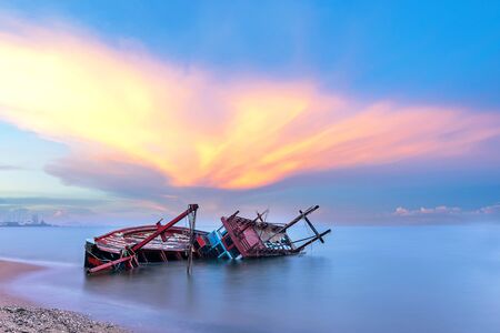 Shipwreck or wrecked boat on beach in the sunset. Beautiful Landscape. Pattaya Thailandの写真素材