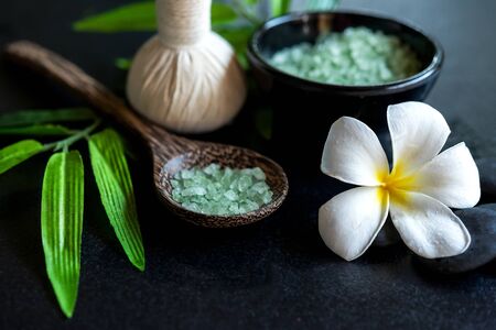 Thai spa composition treatments aroma therapy with candles and Plumeria flowers on wooden table close up. Healthy and Relax Conceptの写真素材