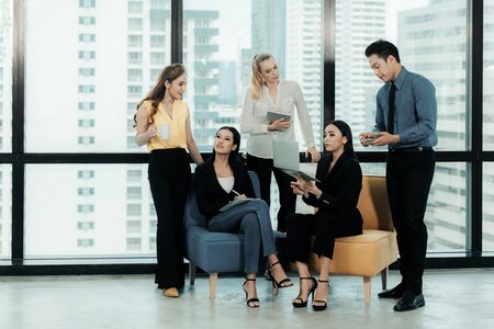 Group of businesspeople using a digital tablet together in office. Business Teamwork partners meeting and brief work. Business Concept.の写真素材
