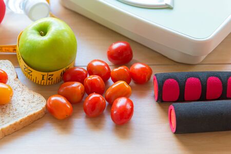 Healthy lifestyle for women diet with sport equipment, sneakers, measuring tape, fruit healthy green...
