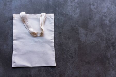 Saving Earth. White tote bag canvas package and fabric cloth eco shopping on blackboard background. Save environment Conceptの写真素材