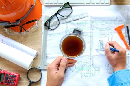 Top View Architect working on blueprint. Architects workplace.  Engineer tools and safety control, ...