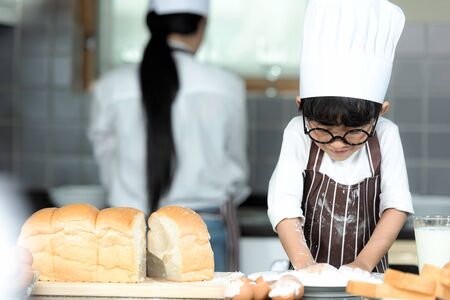 Lifestyle Family. Chef asian mother and kid boy cooking toast and make  bread for dinner.  Asian son help mom making sweet food, so happy and enjoy.  Family Concept.
の写真素材