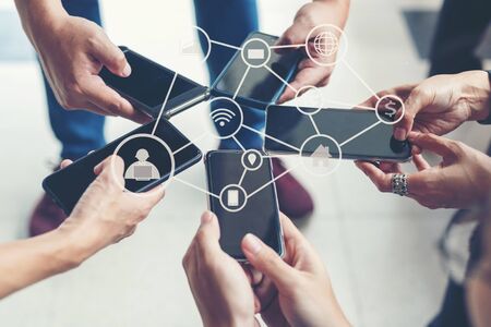 Close up group hand people use laptop and smartphone for connection internet.  Business use social network and use technology for communication business life.  Technology and Communication Conceptの写真素材