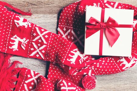 Gift and present with wearing sweater on Christmas and Happy New year. Red present on backboard background.  Merry Christmas and Holiday Conceptの写真素材