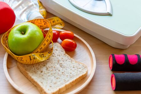 Healthy lifestyle for women diet weight scale with dumbbells sport equipment, sneakers, measuring...