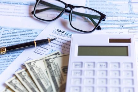 Calculating tax refund or income tax return for saving tax, target for save coin in the piggy bank. Tax and Saving Conceptの写真素材