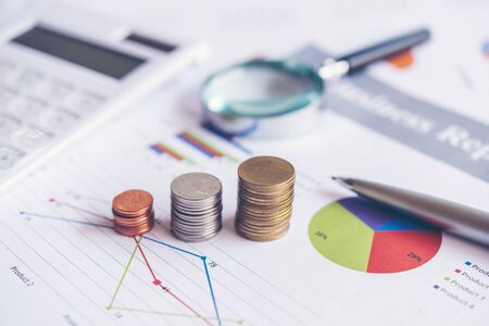 Growth economic on stack of coins on report paper analyze performance financial graph funding with calculate for investment business. Investment and Saving Conceptの写真素材